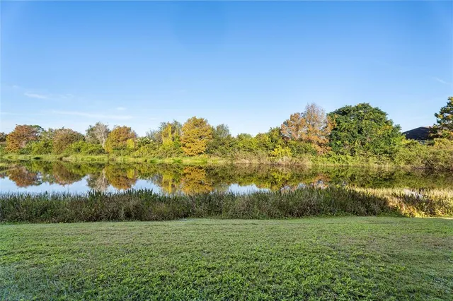 a view of a field with a house in background