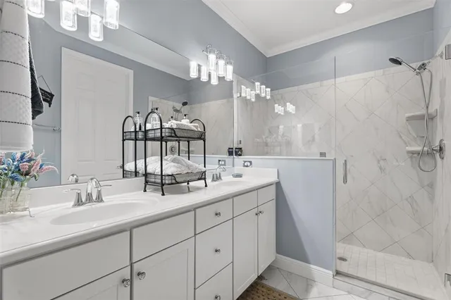 a bathroom with double vanity and a mirror