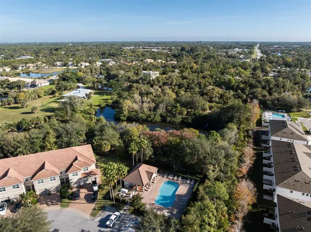 an aerial view of a house with a yard