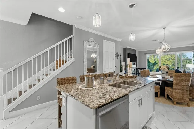 a kitchen with sink island and view living room