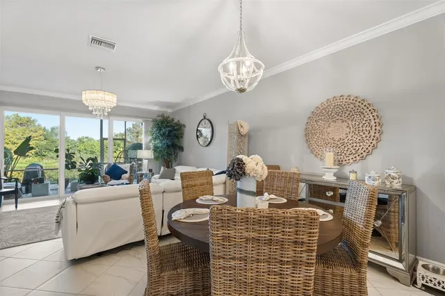 a living room with furniture a chandelier and a fireplace