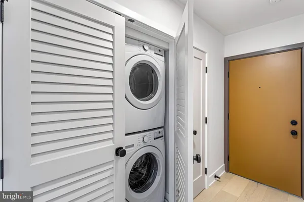 a view of a hallway with washer and dryer
