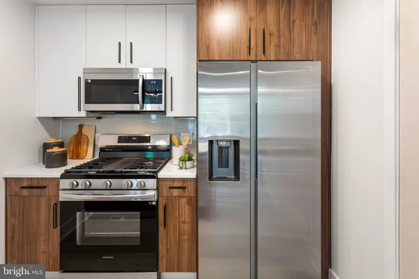a kitchen with stainless steel appliances granite countertop a stove and a refrigerator