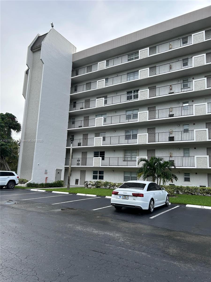 3100 West Rolling Hills Circle, Unit 702 Davie, FL 33328 - Photo 4 of 16 a car parked in front of a building