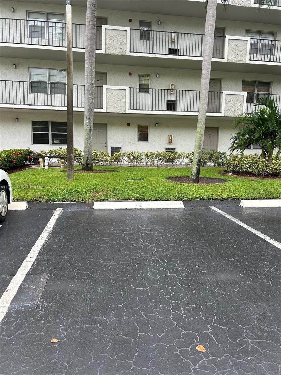 3100 West Rolling Hills Circle, Unit 702 Davie, FL 33328 - Photo 5 of 16 a view of a street with a building in the background