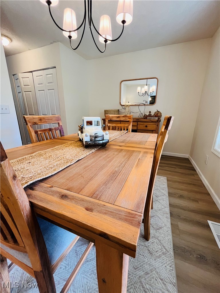 3811 Center Road Perry, OH 44081 - Photo 3 of 50 Dining space featuring a chandelier and wood finished floors