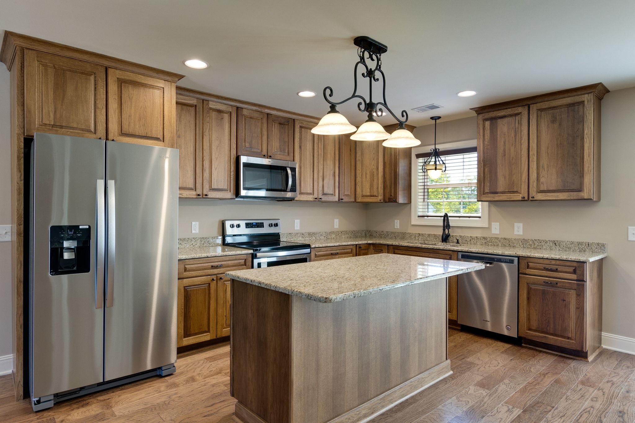 7703 South Swift Road Goodlettsville, TN 37072 - Photo 2 of 12 a kitchen with stainless steel appliances granite countertop a sink a stove a refrigerator cabinets and a kitchen island