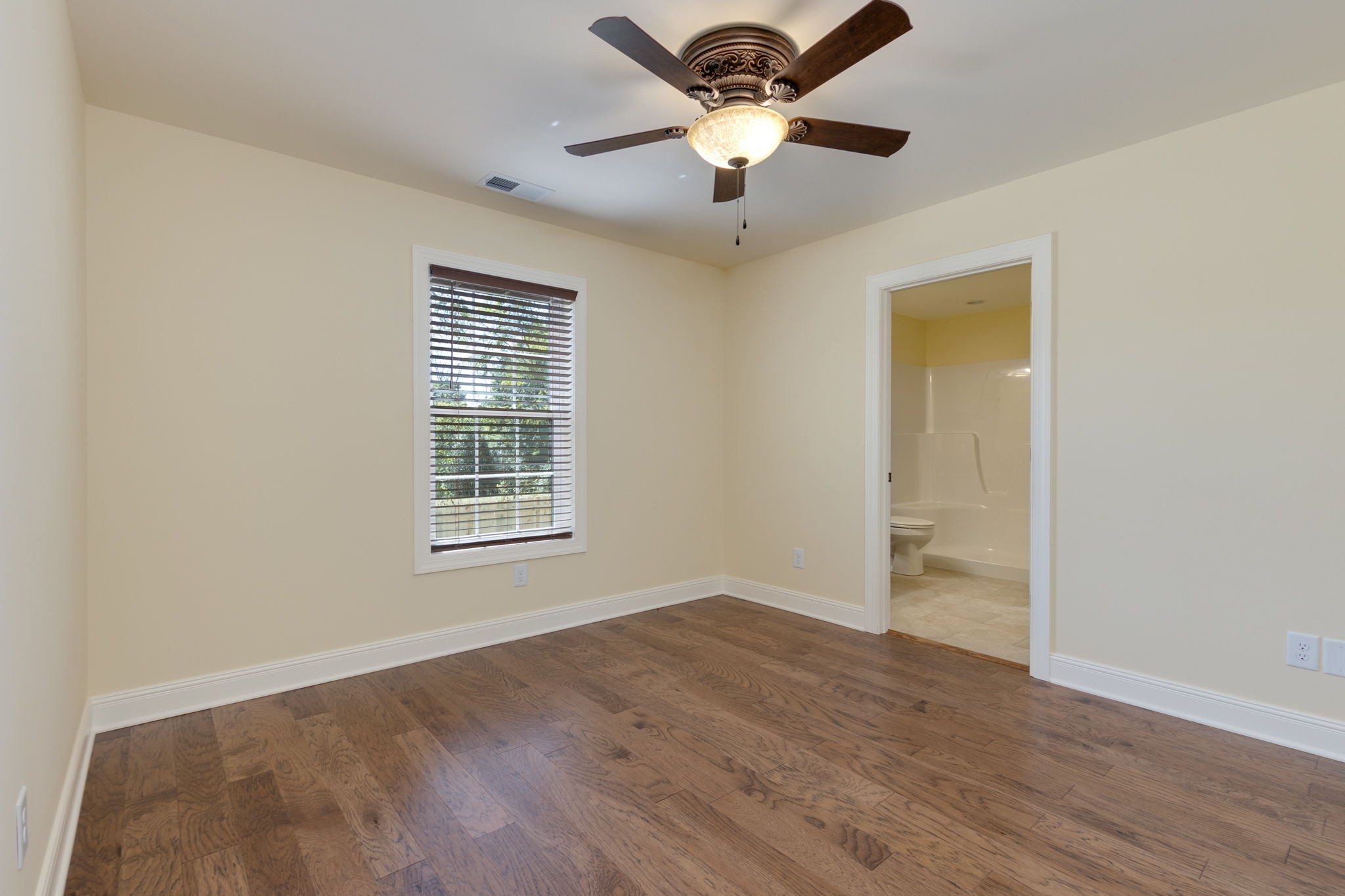 7703 South Swift Road Goodlettsville, TN 37072 - Photo 3 of 12 a view of an empty room with a window and wooden floor