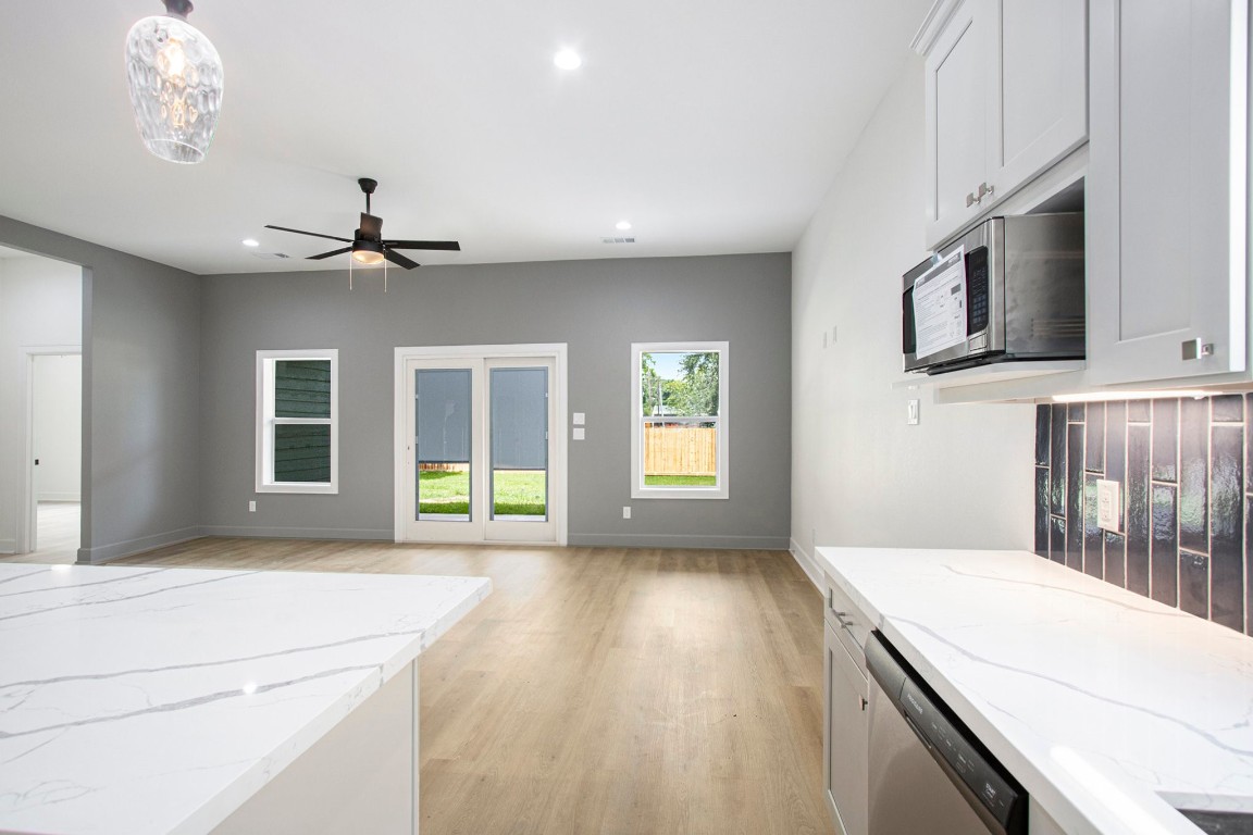 3810 Jackson Street Santa Fe, TX 77517 - Photo 11 of 29 a living room with stainless steel appliances kitchen island furniture and a window