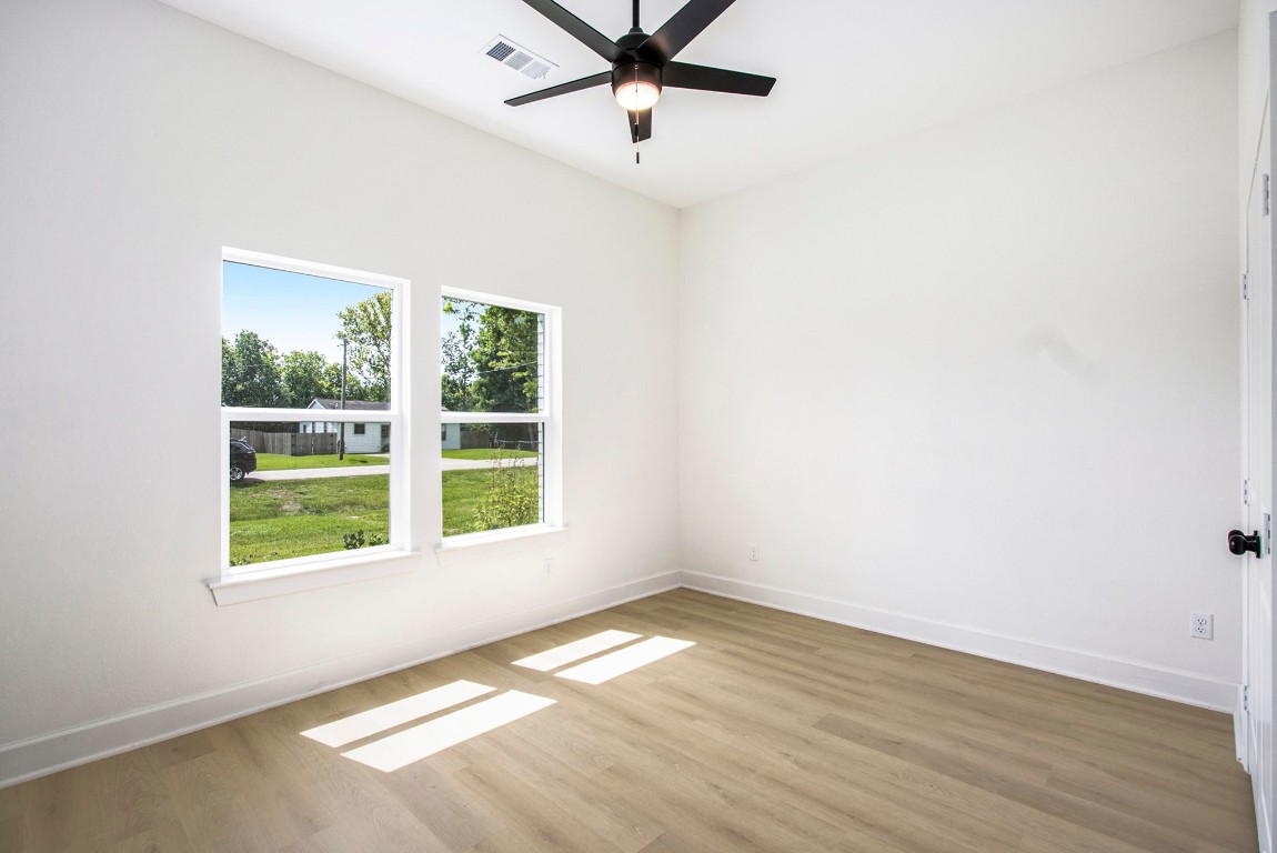 3810 Jackson Street Santa Fe, TX 77517 - Photo 20 of 29 wooden floor in an empty room with a window
