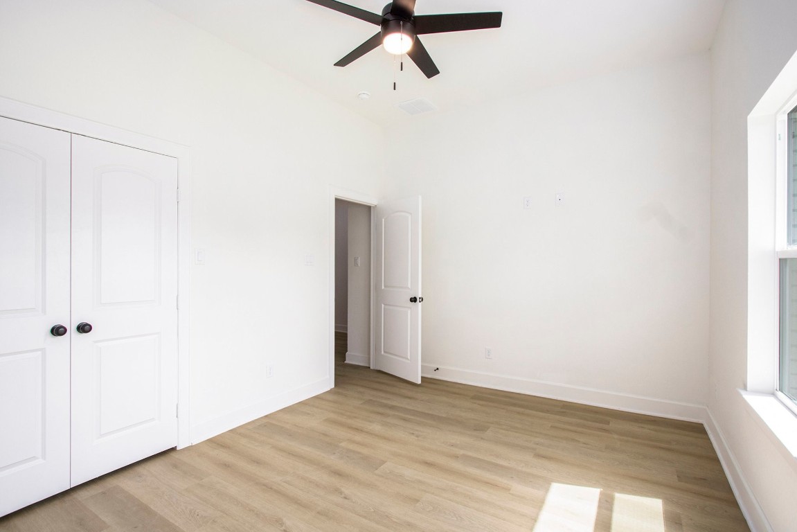 3810 Jackson Street Santa Fe, TX 77517 - Photo 22 of 29 a view of a room with wooden floor and ceiling fan