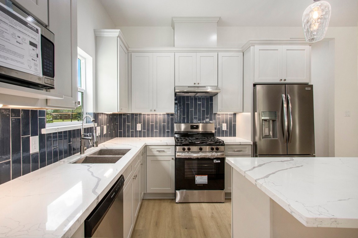 3810 Jackson Street Santa Fe, TX 77517 - Photo 10 of 29 a kitchen with a stove sink and refrigerator