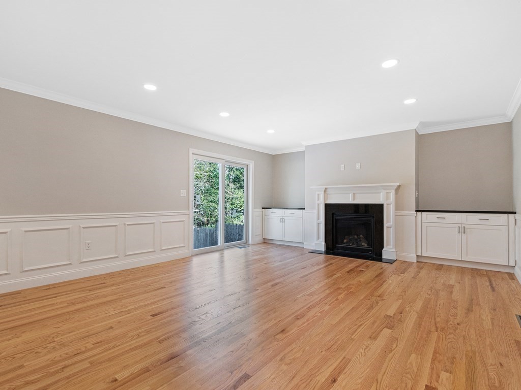 33 Circle Drive Waltham, MA 02452 - Photo 12 of 42 a view of empty room with wooden floor and fireplace