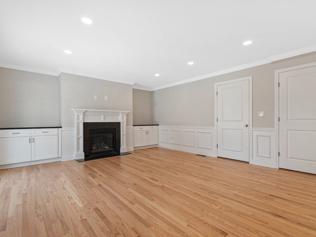 33 Circle Drive Waltham, MA 02452 - Photo 14 of 42 a view of empty room with wooden floor and fireplace