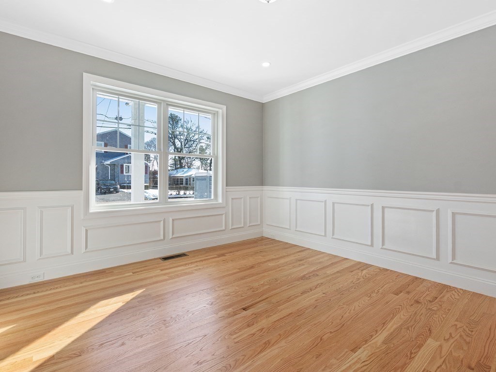 33 Circle Drive Waltham, MA 02452 - Photo 16 of 42 a view of an empty room with a window and wooden floor