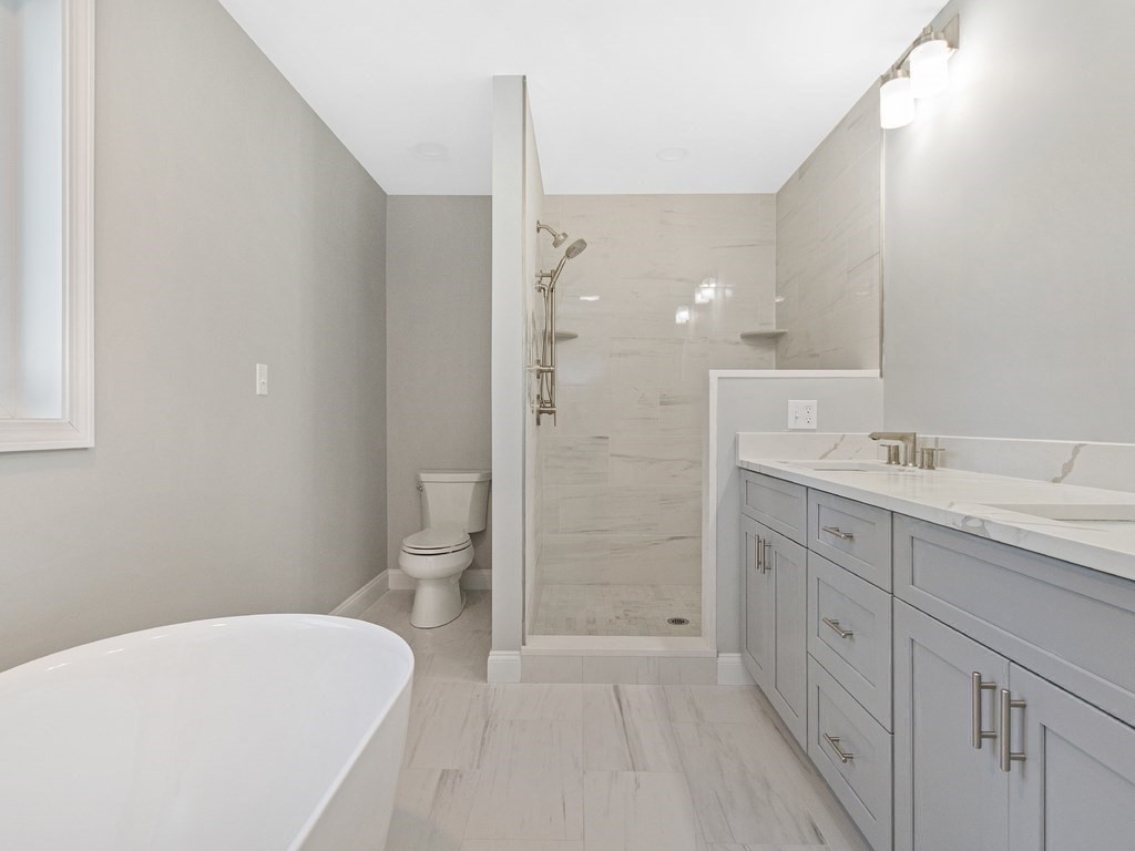33 Circle Drive Waltham, MA 02452 - Photo 27 of 42 a spacious bathroom with a granite countertop sink a toilet and shower