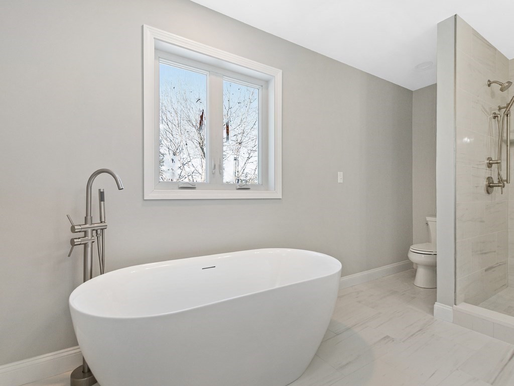 33 Circle Drive Waltham, MA 02452 - Photo 29 of 42 a white bath tub sitting in a bathroom