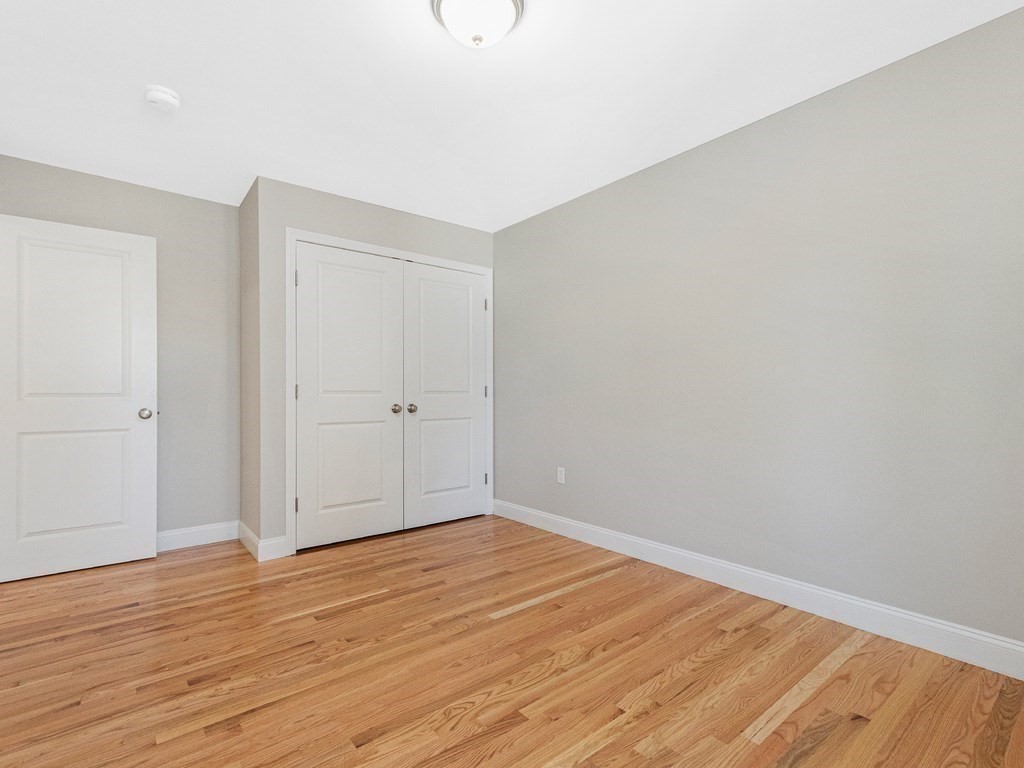33 Circle Drive Waltham, MA 02452 - Photo 33 of 42 a view of an empty room with wooden floor