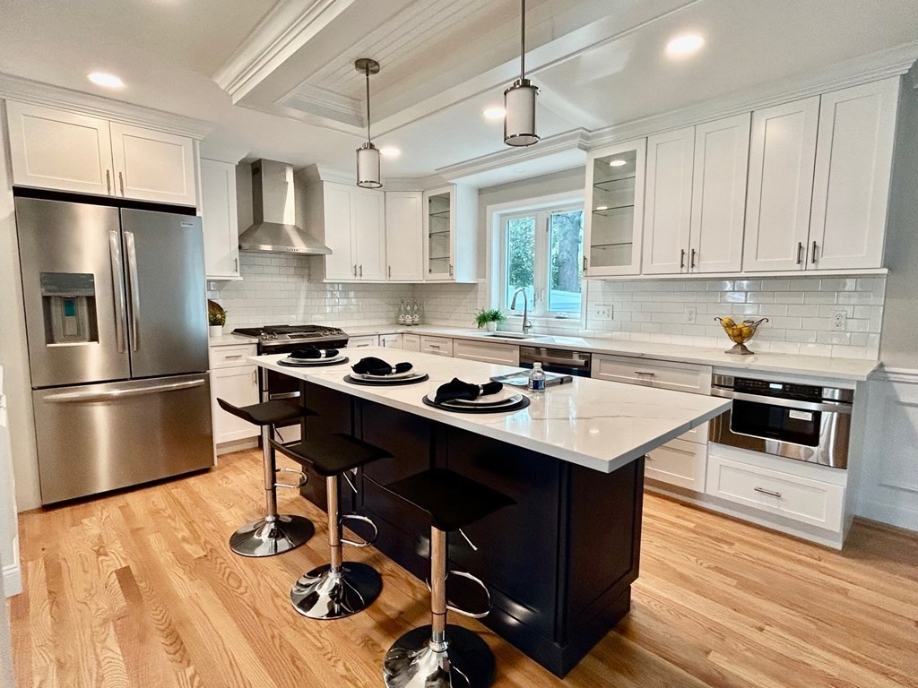 33 Circle Drive Waltham, MA 02452 - Photo 4 of 42 a kitchen with kitchen island a sink appliances and cabinets