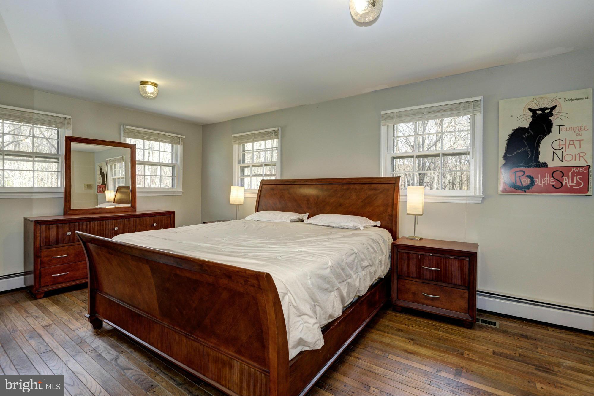 7015 Deer Valley Road Highland, MD 20777 - Photo 14 of 30 a bedroom with a bed and wooden floor