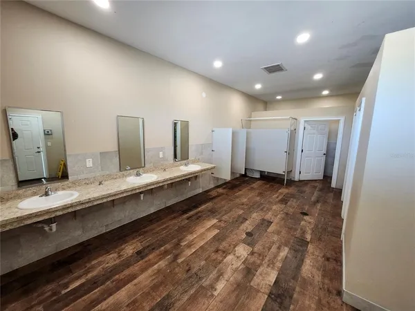 a bathroom with a sink mirror and a toilet