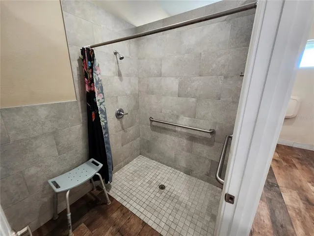 a view of a patio with a table and chairs under an umbrella