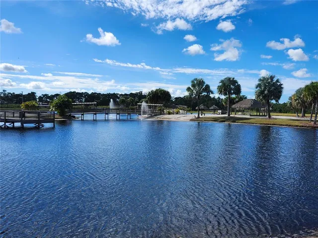 a view of a swimming pool and outdoor seating