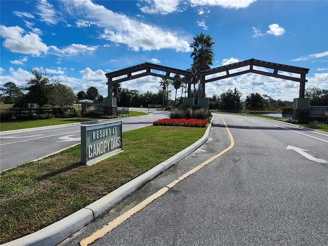 a view of a swimming pool with a yard and sitting area