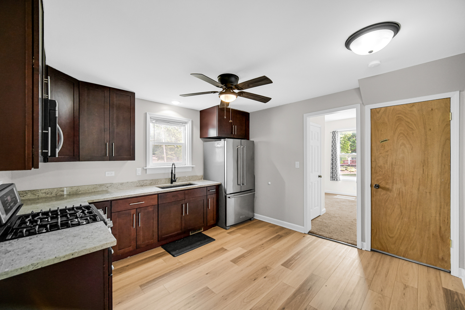 110 Wood Elwood, IL 60421 - Photo 6 of 23 a kitchen with stainless steel appliances granite countertop a sink stove and refrigerator