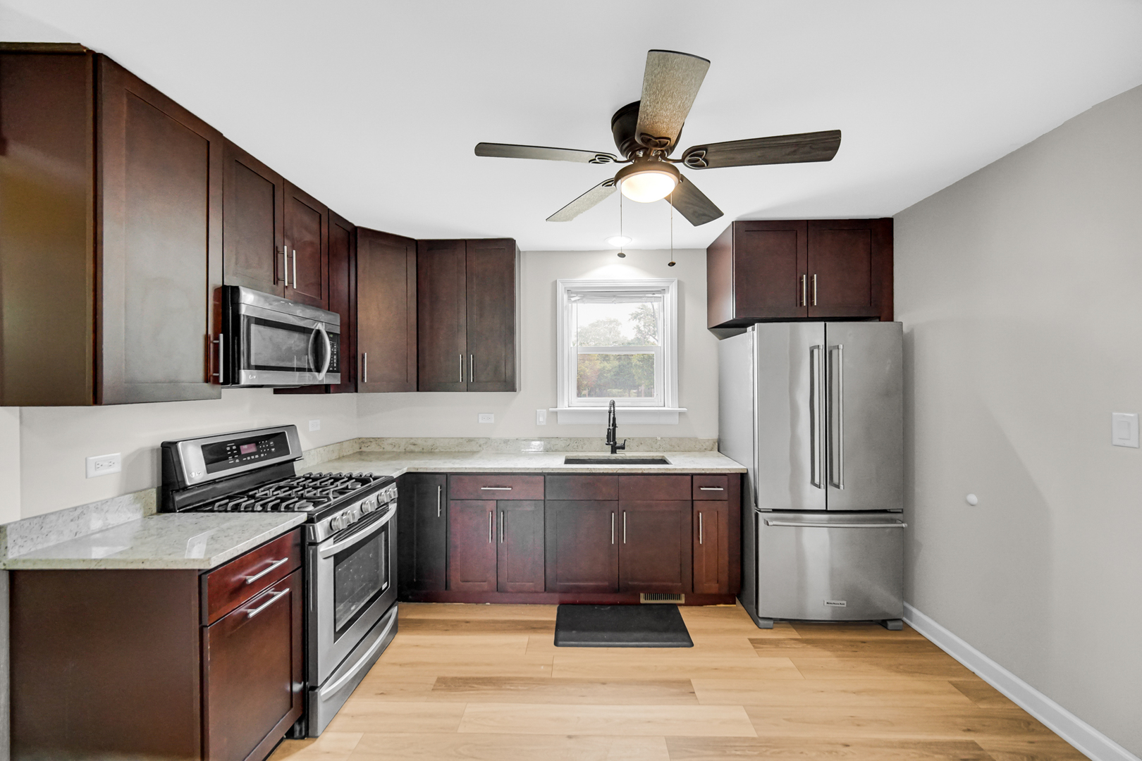 110 Wood Elwood, IL 60421 - Photo 7 of 23 a kitchen with stainless steel appliances granite countertop a refrigerator a stove a sink and a microwave
