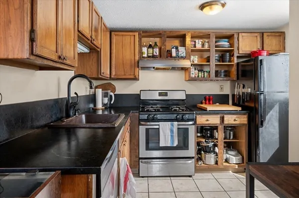 a kitchen with stainless steel appliances granite countertop a stove and a refrigerator