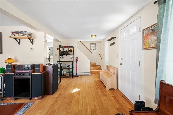 a view of entryway with wooden floor and livingroom
