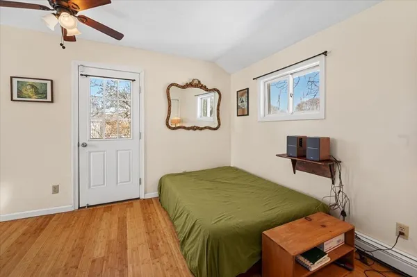 a bedroom with a bed and a ceiling fan