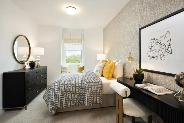 a bedroom with bed and a table