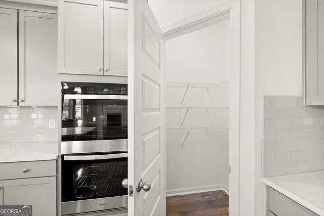 a large kitchen with kitchen island a large island in the center and stainless steel appliances