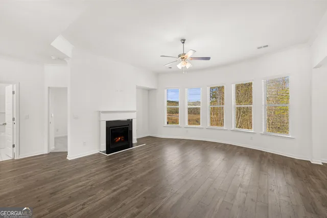 a view of a livingroom with a fireplace and wooden floor