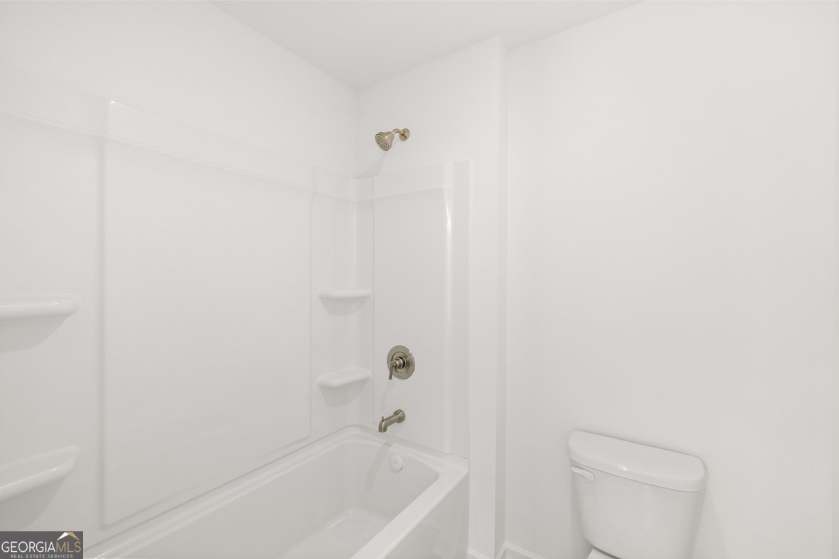 400 Hazel Drive Locust Grove, GA 30248 - Photo 45 of 50 a bathroom with a bathtub and a toilet