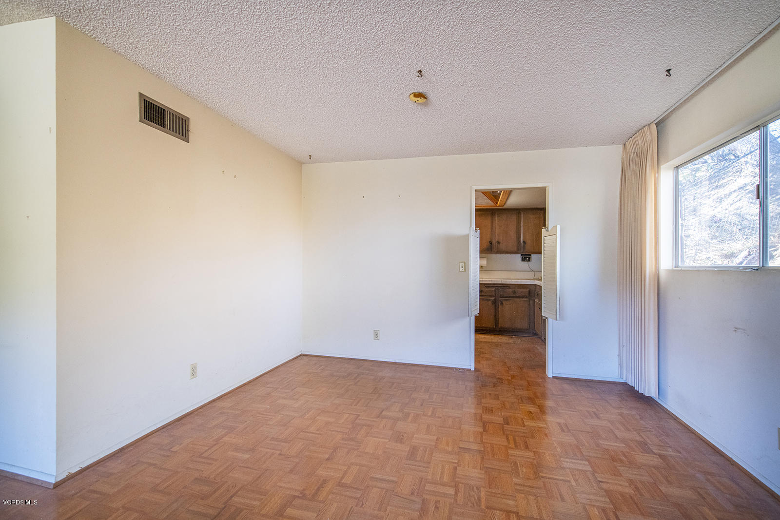 4435 Erbes Road Thousand Oaks, CA 91360 - Photo 2 of 14 a view of empty room with wooden floor and cabinet