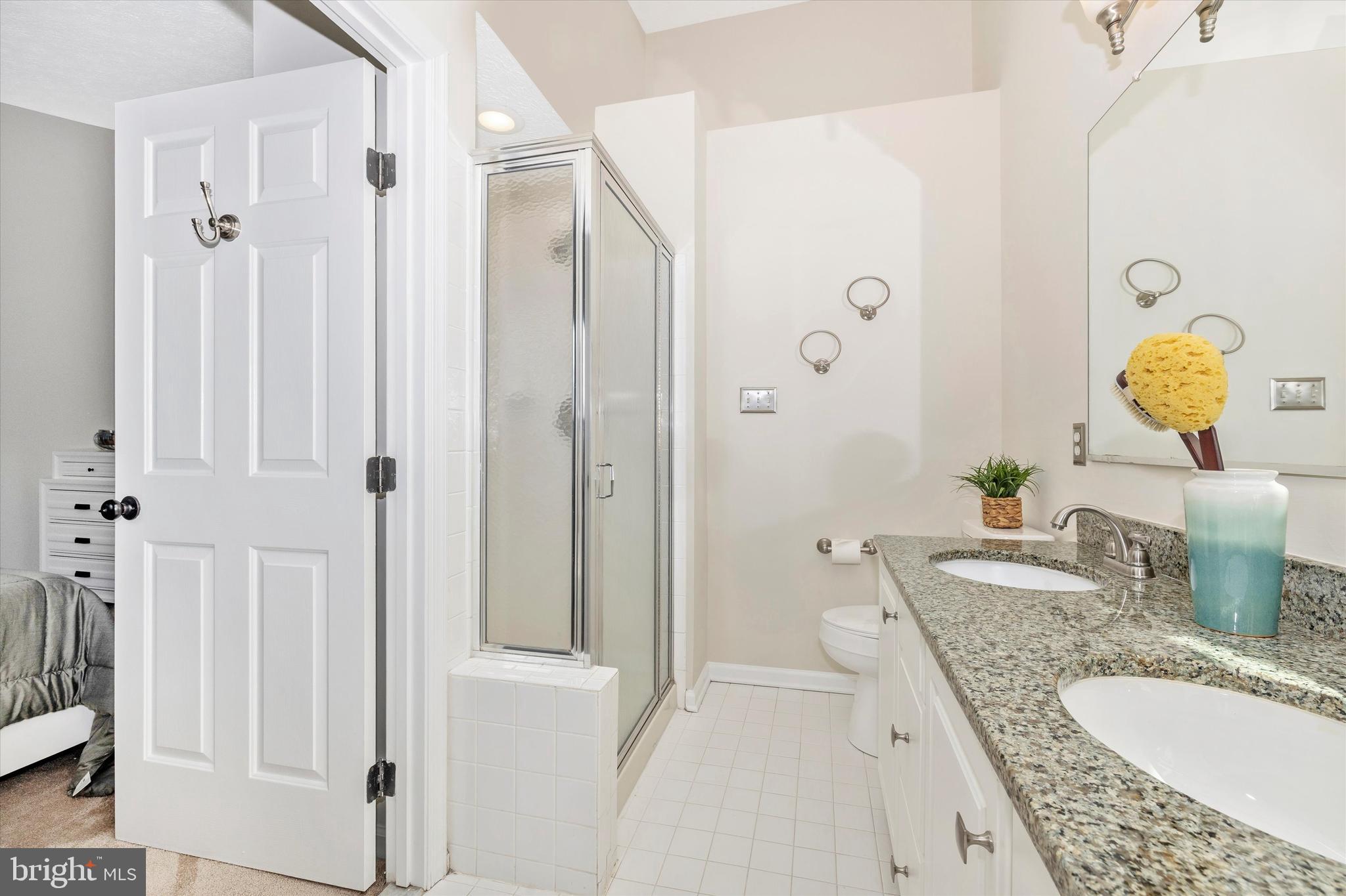 2010 Sumner Drive Frederick, MD 21702 - Photo 16 of 34 a bathroom with a granite countertop double vanity sink mirror and shower