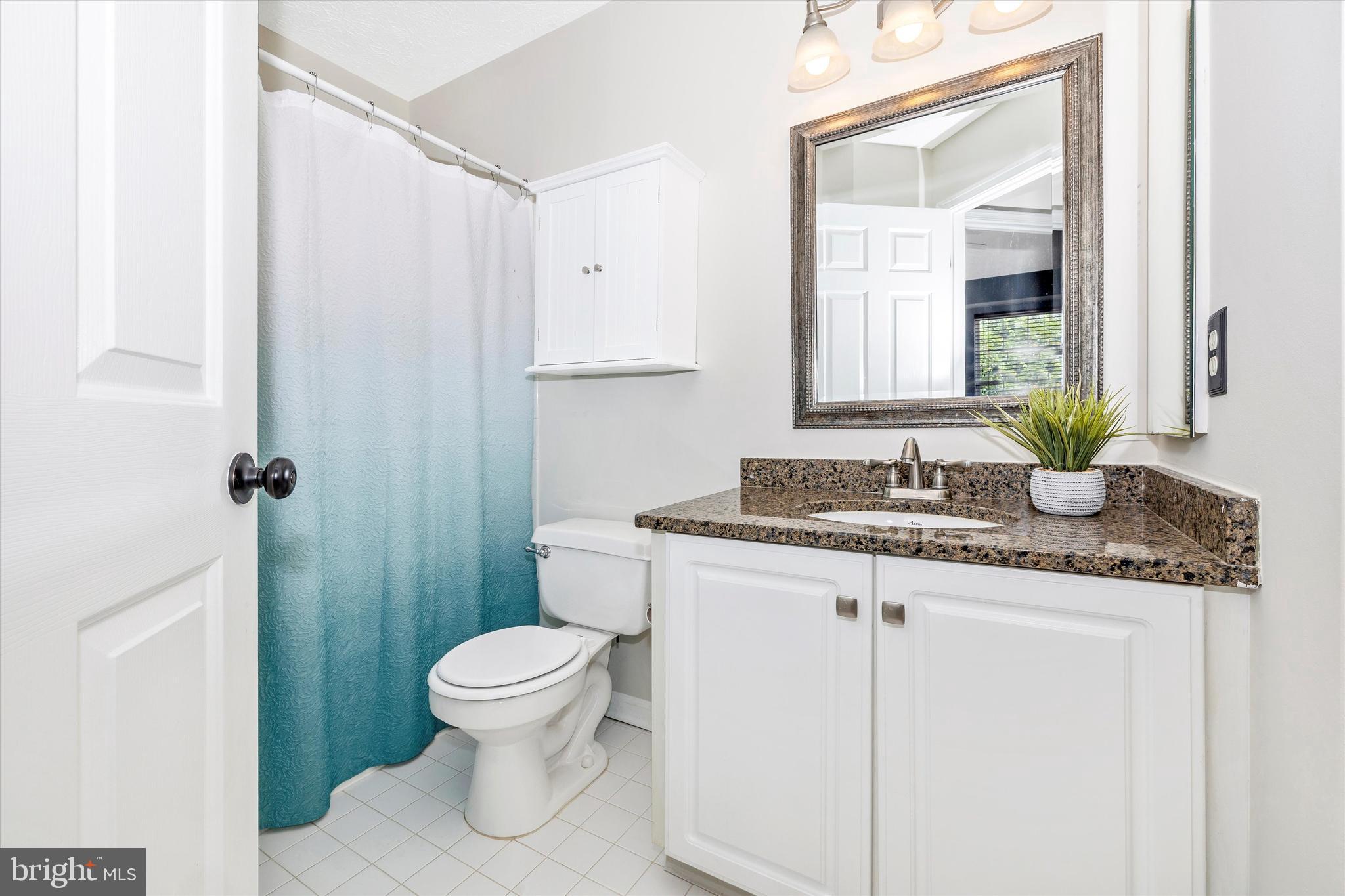 2010 Sumner Drive Frederick, MD 21702 - Photo 21 of 34 a bathroom with a granite countertop sink toilet and mirror
