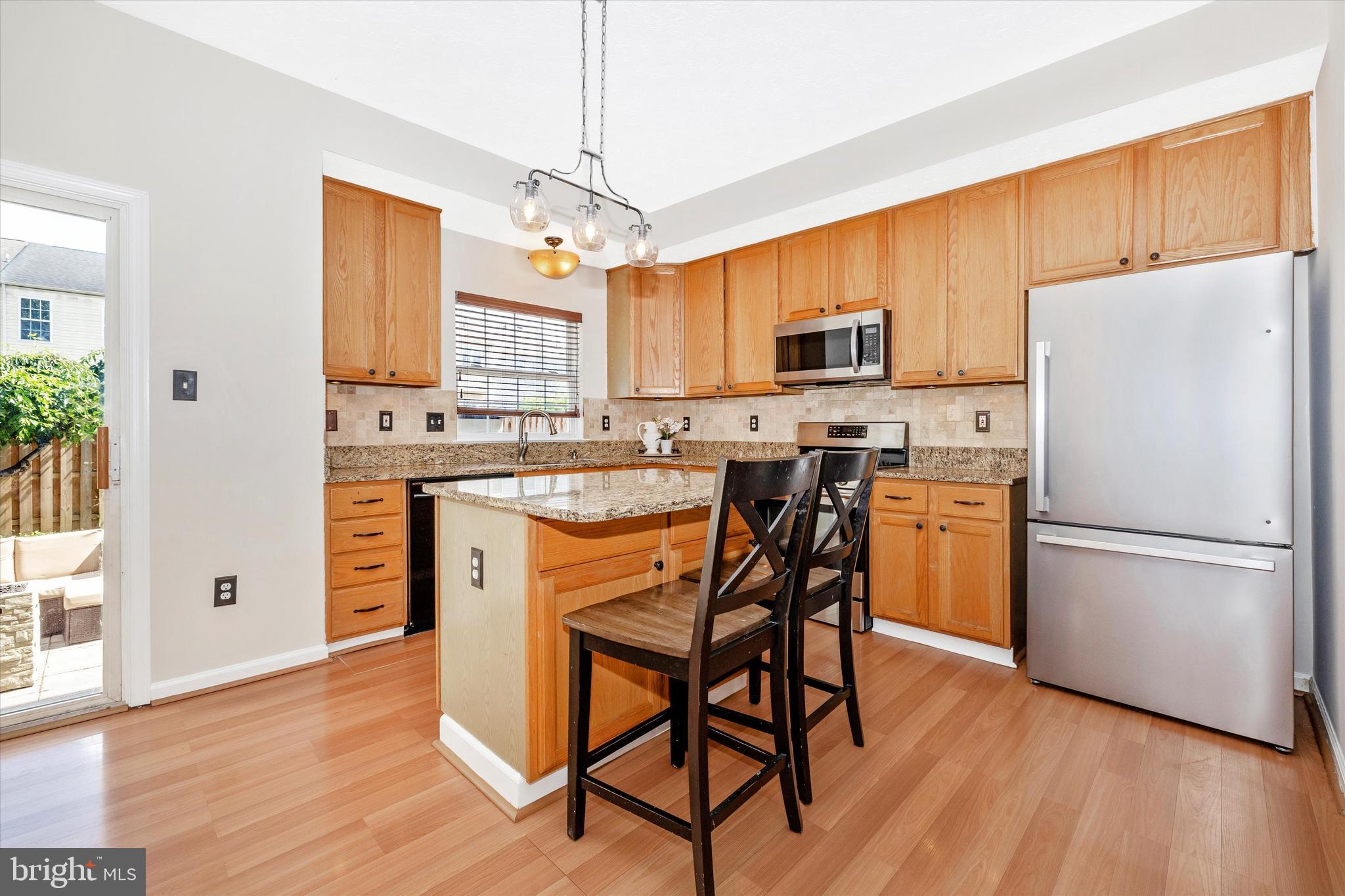 2010 Sumner Drive Frederick, MD 21702 - Photo 3 of 34 a kitchen with stainless steel appliances granite countertop a refrigerator a stove a sink dishwasher and a refrigerator with wooden floor
