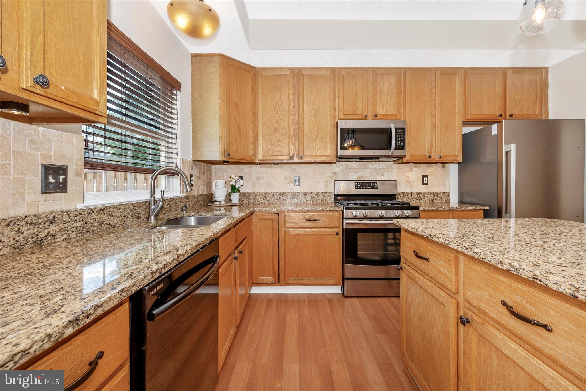 2010 Sumner Drive Frederick, MD 21702 - Photo 4 of 34 a kitchen with granite countertop a sink a counter top space stainless steel appliances and cabinets