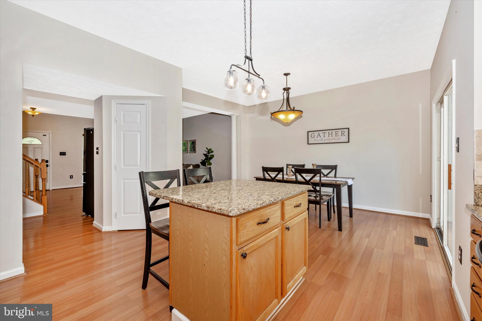 2010 Sumner Drive Frederick, MD 21702 - Photo 5 of 34 a view of a kitchen counter space a sink wooden floor and a chandelier