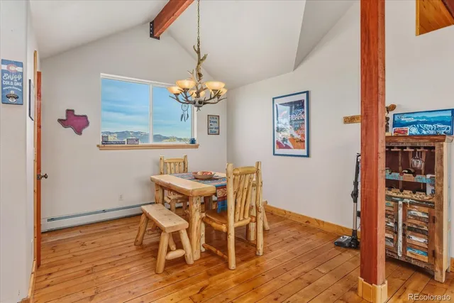 a view of a dining room with furniture wooden floor and chandelier