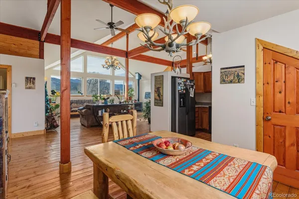 a living room with hard wood floor furniture and a table