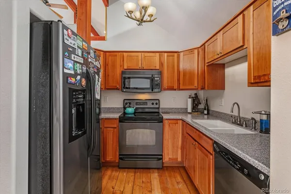 a kitchen with stainless steel appliances granite countertop a refrigerator and a sink