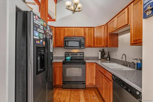 a kitchen with stainless steel appliances granite countertop a refrigerator and a sink