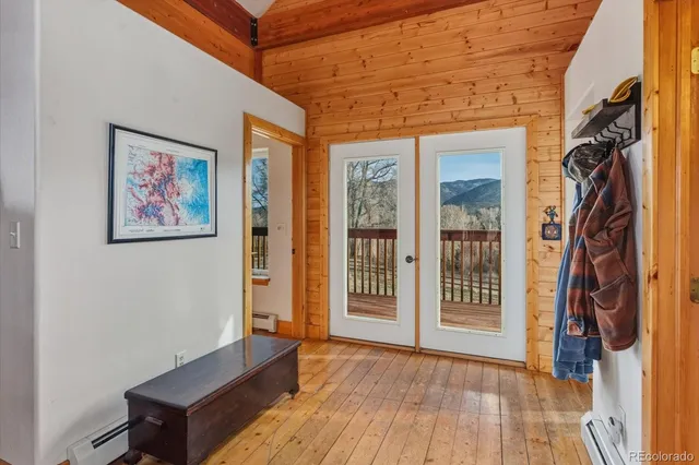 a view of an entryway with wooden floor