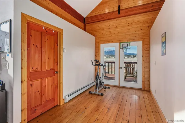 a view of a hallway with wooden floor and closet