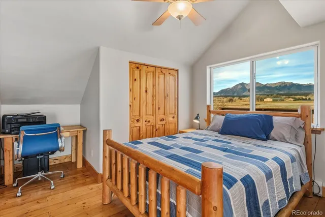 a bedroom with a bed and a large window